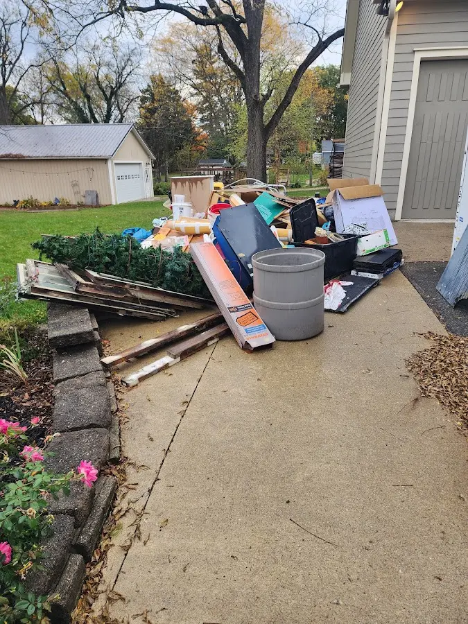 Dumpster being loaded with debris for Roofing Dumpster Rental in Montesano